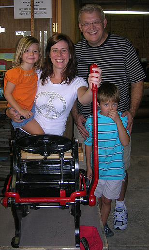 Dennis Couch
                                & Family with their new printing
                                press!