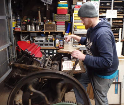 Nephew Jerrod printing Wedding
                Coasters at Excelsior Press